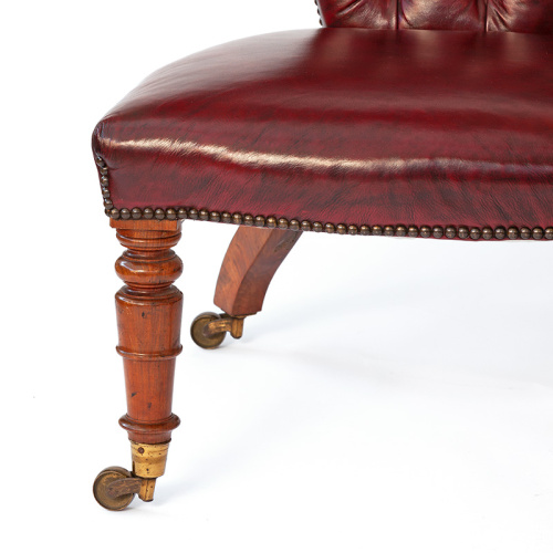 Antique polished oak cockfighting chair in dark red leather with original brass castors (c.1860)
