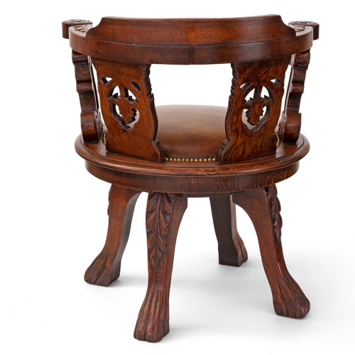 Antique heavily carved fully rotating oak ships chair with tan leather seat (c.1880)